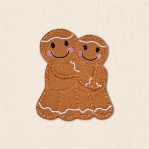 Embroidered felt Mr & Mrs gingerbread couple embracing, with smiling faces, pink cheeks and white icing details.