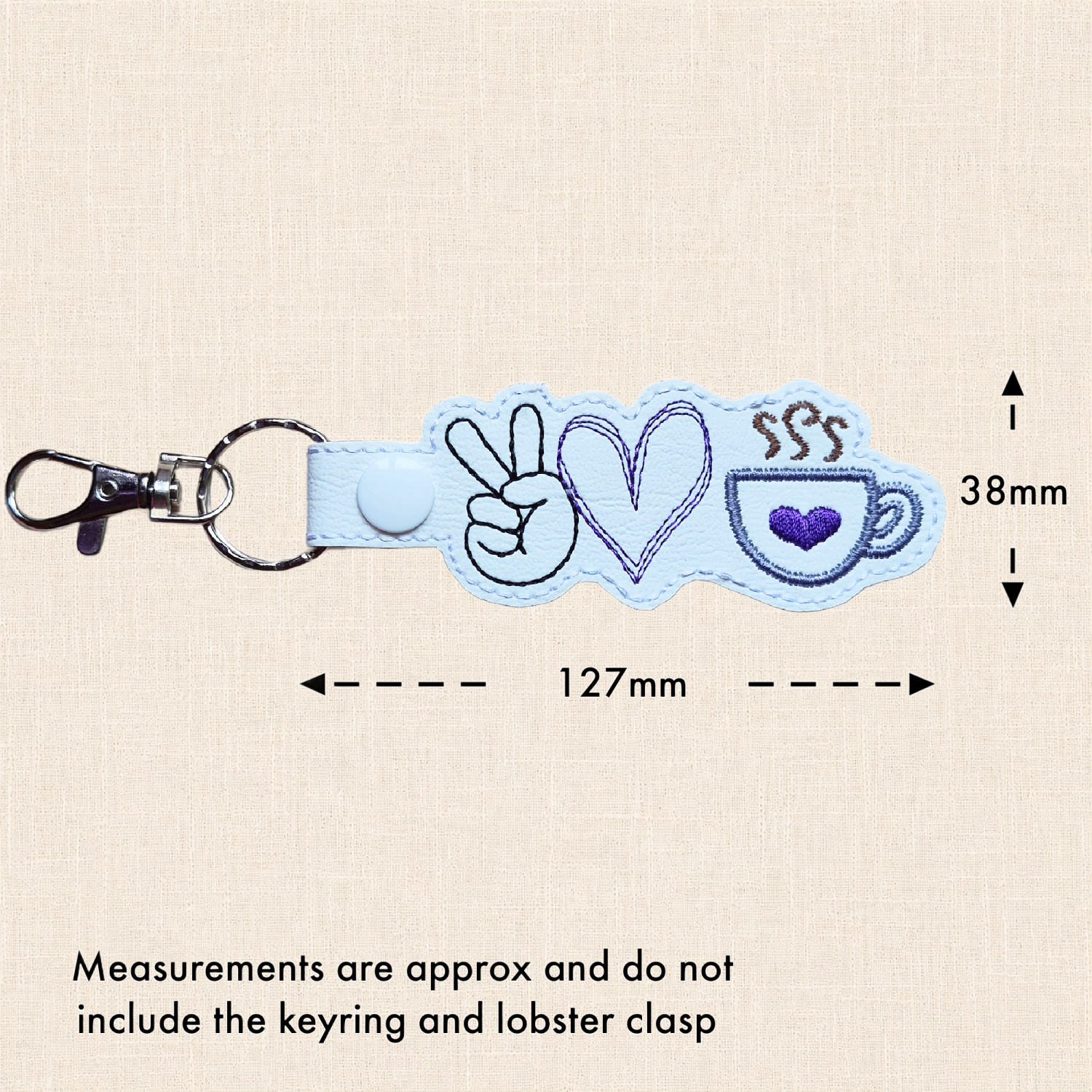 White peace, love and coffee keyring with measurements showing approximately 127mm wide x 38mm high, excluding the split ring and lobster clasp.
