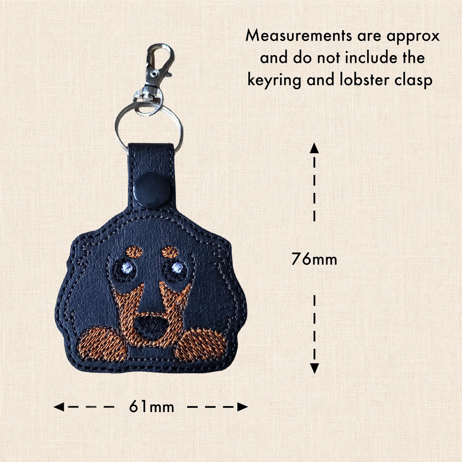 Long haired Dachshund keyring with arrows showing approximately 61mm wide and 76mm high, excluding the split ring and lobster clasp.