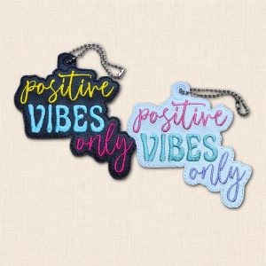 Black and white 'Positive Vibes Only' embroidered faux leather charms with colourful wording and metal ball chains.