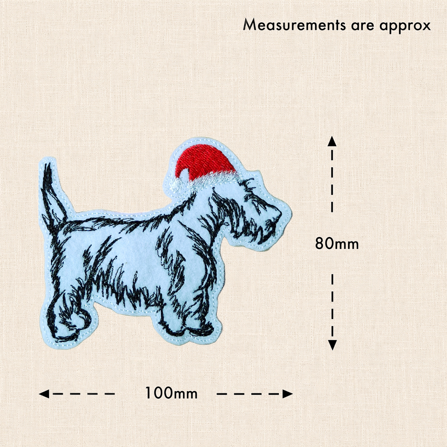 Scottish Terrier Christmas decoration with measurement arrows showing approximately 100mm wide x 80mm high, excluding the hanging ribbon.