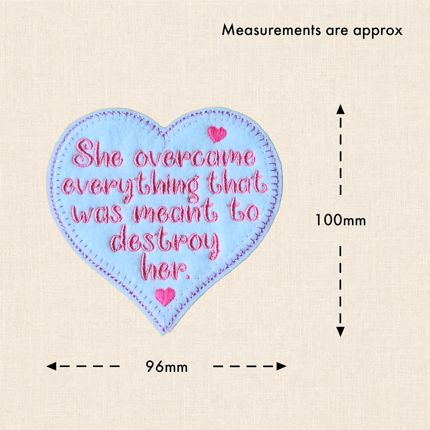 'She overcame everything that was meant to destroy her' felt heart with measurement arrows showing approximately 100mm high and 96mm wide.