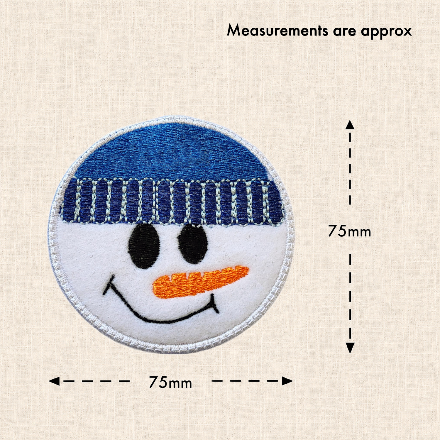 1. Snow Boy felt decoration wearing a blue winter hat, with measurement arrows showing approximately 75mm wide x 75mm high.