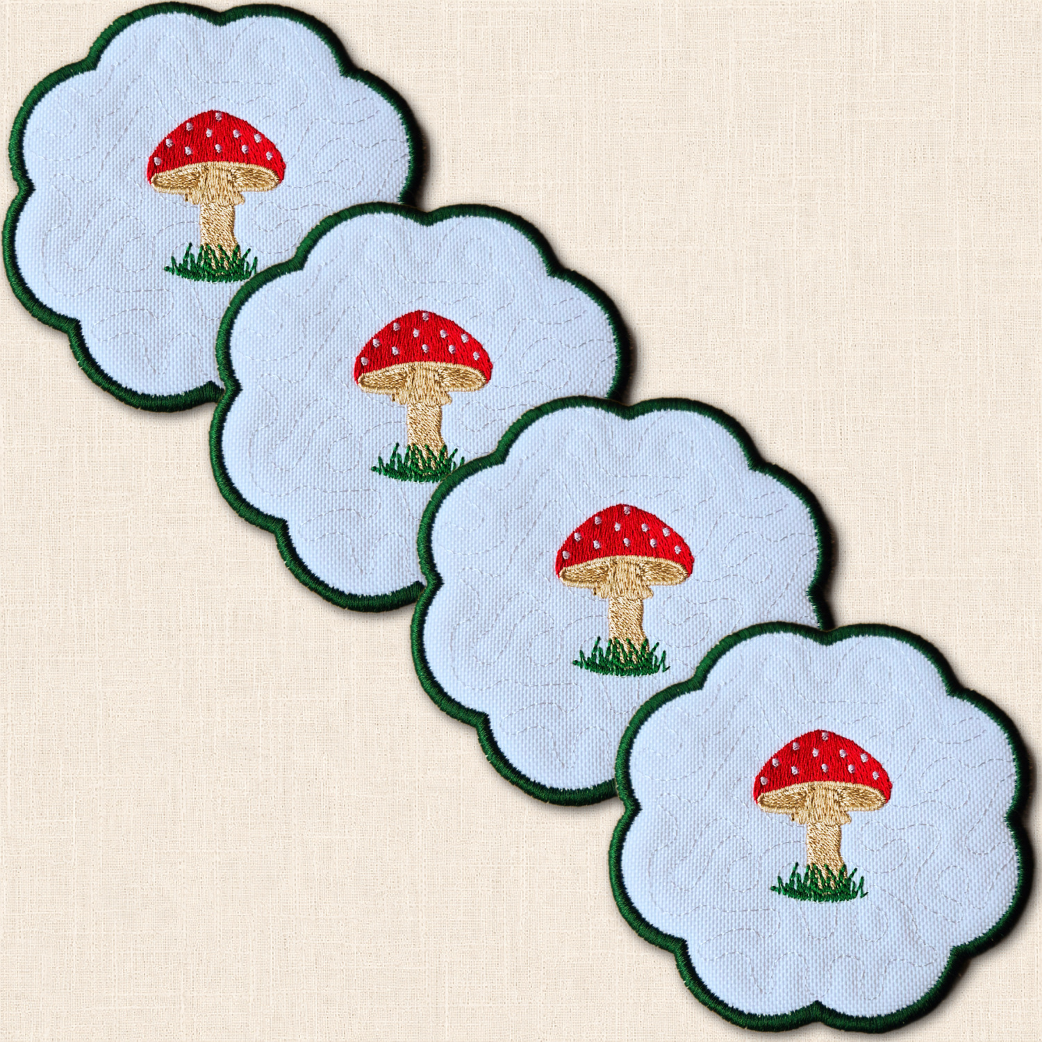 Four overlapping toadstool candle coasters with red spotted caps, beige stems and green scalloped edges.